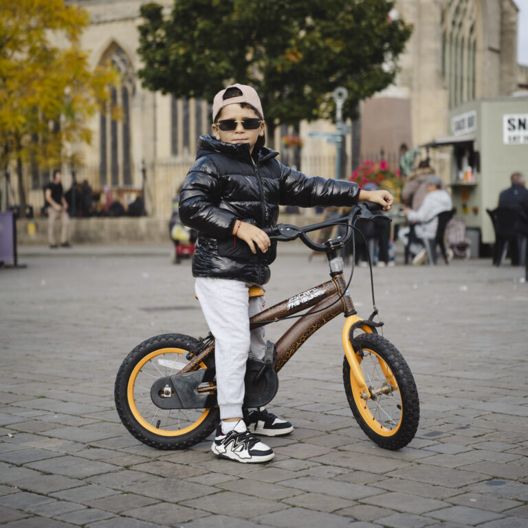 Portrait by Steven Hatton of a young cyclist in Boston town centre, part of The Bostonians community exhibition