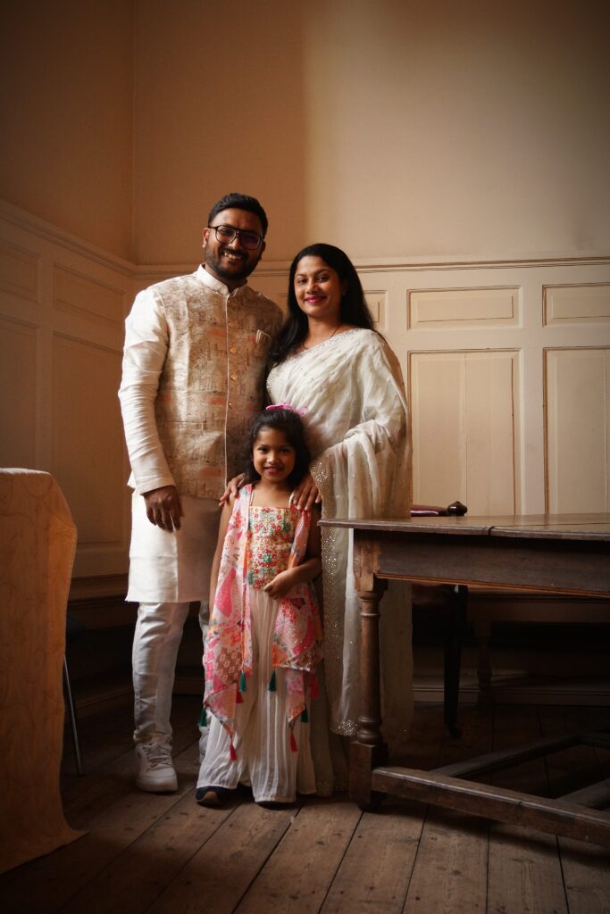 Portrait by Bartosz Fedkowicz of a family standing together indoors in Boston, part of the Kaleidoscope photography exhibition