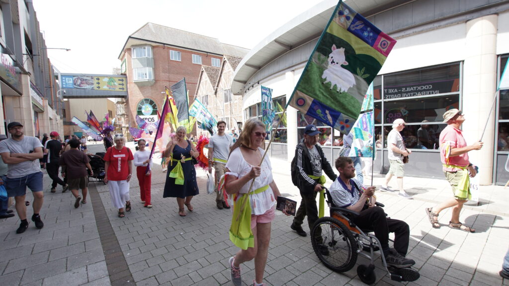 Community parade in Boston Lincolnshire featuring colourful Hanse banners created by local residents for Hanse Day celebrations
