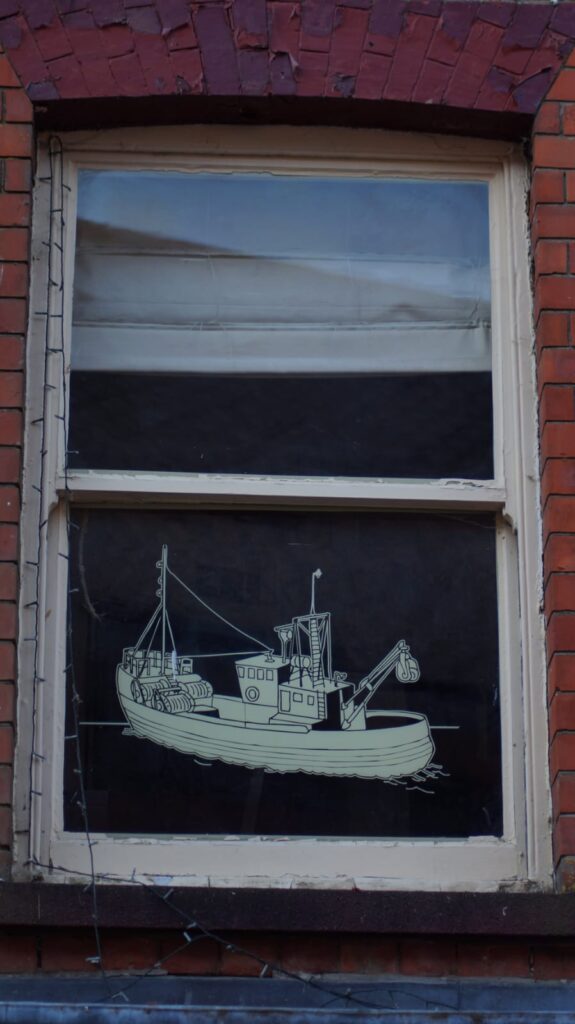A window with an image of a boat in vinyl