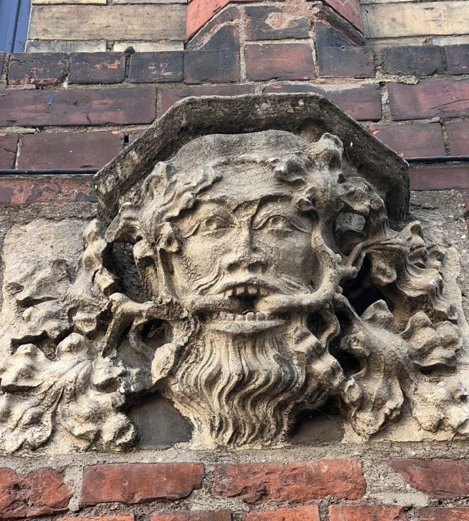 A carved stone face on a historic building
