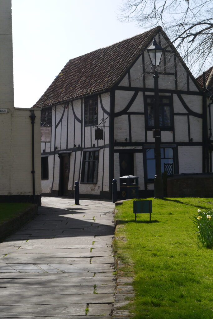 Wide shot of a wobbly historic Tudor house, Church House by St Botolphs in Boston