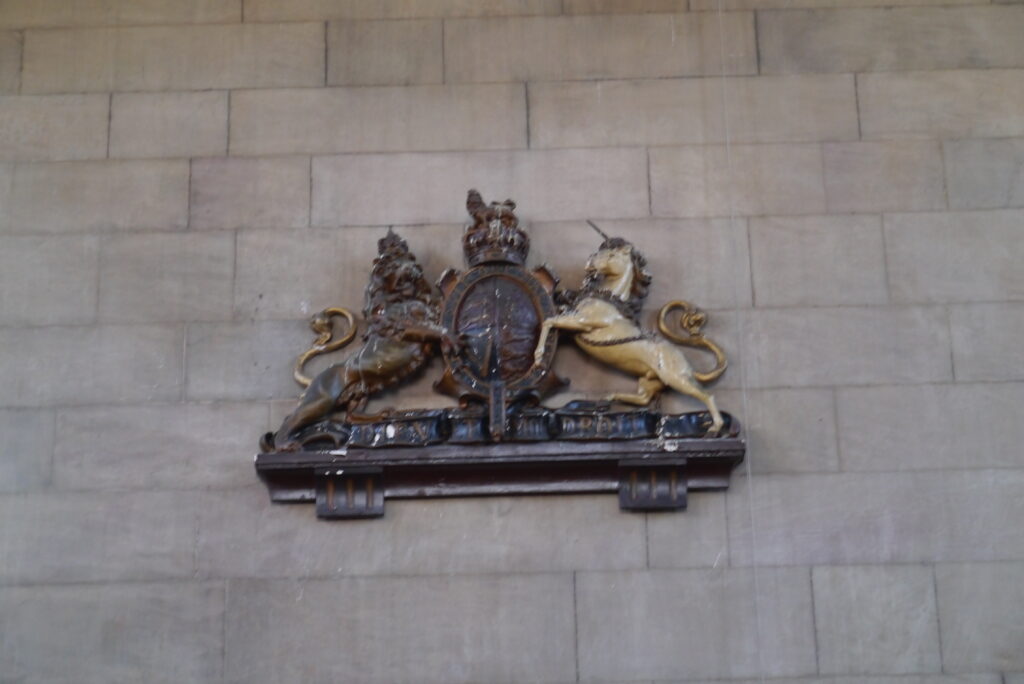 An image of the United Kingdom's coat of arms on the side of a building