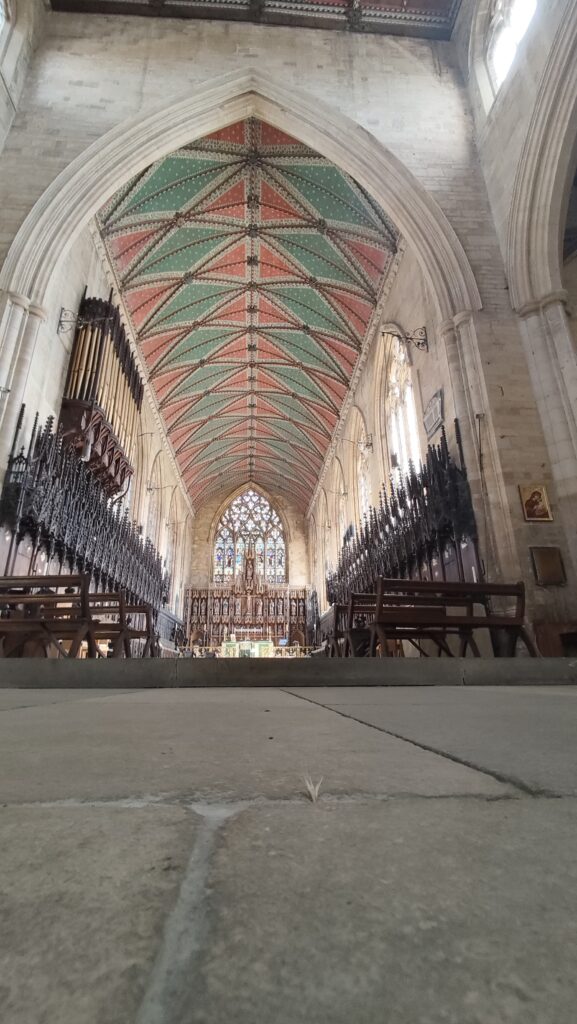 A picture of the interior of St Botolphs, focused on the colourful ceiling