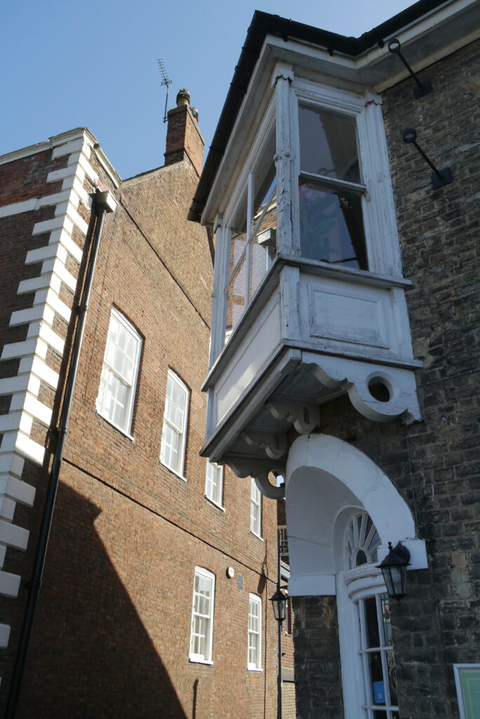 An overhanging window on a historic building on Boston's South Street