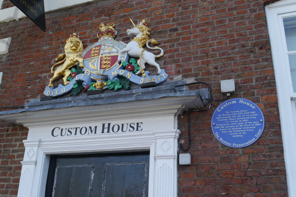Doorway of Custom House Boston, a Georgian doorway featuring a colourful 3D emblem of the UK Coat of Arms