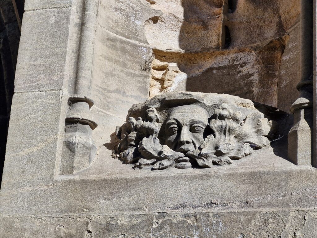 A green man decorative stone carving on a building in Boston
