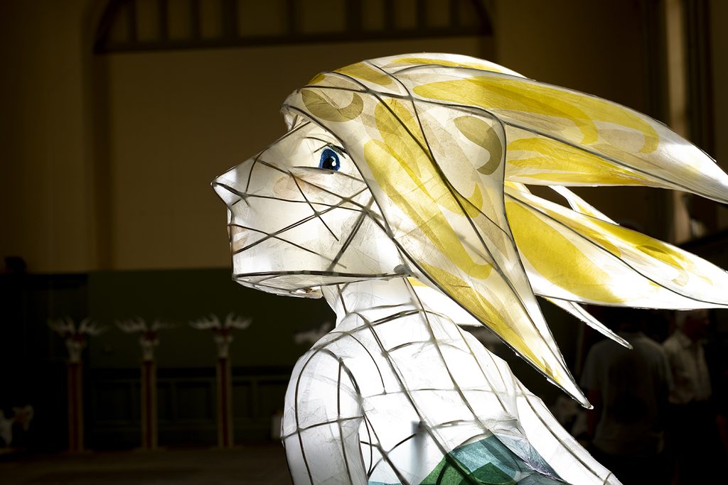 A midshot of the shoulders and head of Transported's illuminated giant mermaid lantern made by Lumo Workshop