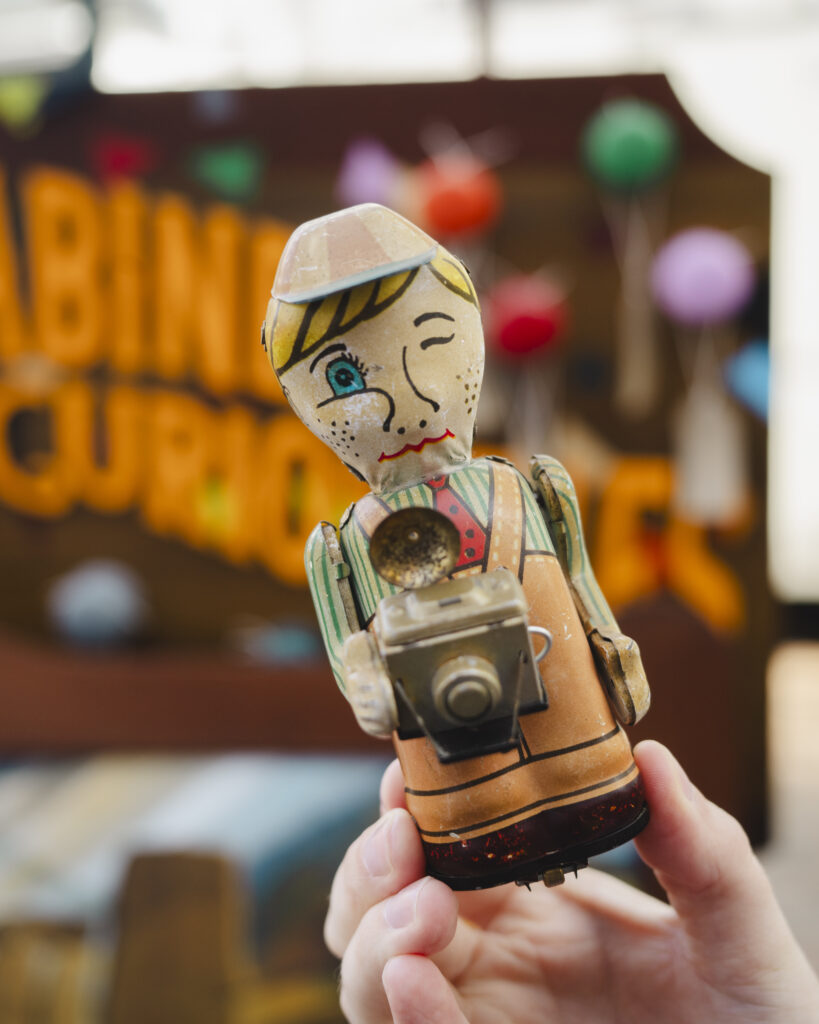 A close up of a curious vintage camera man toy found in the Cabinet of Curiosities