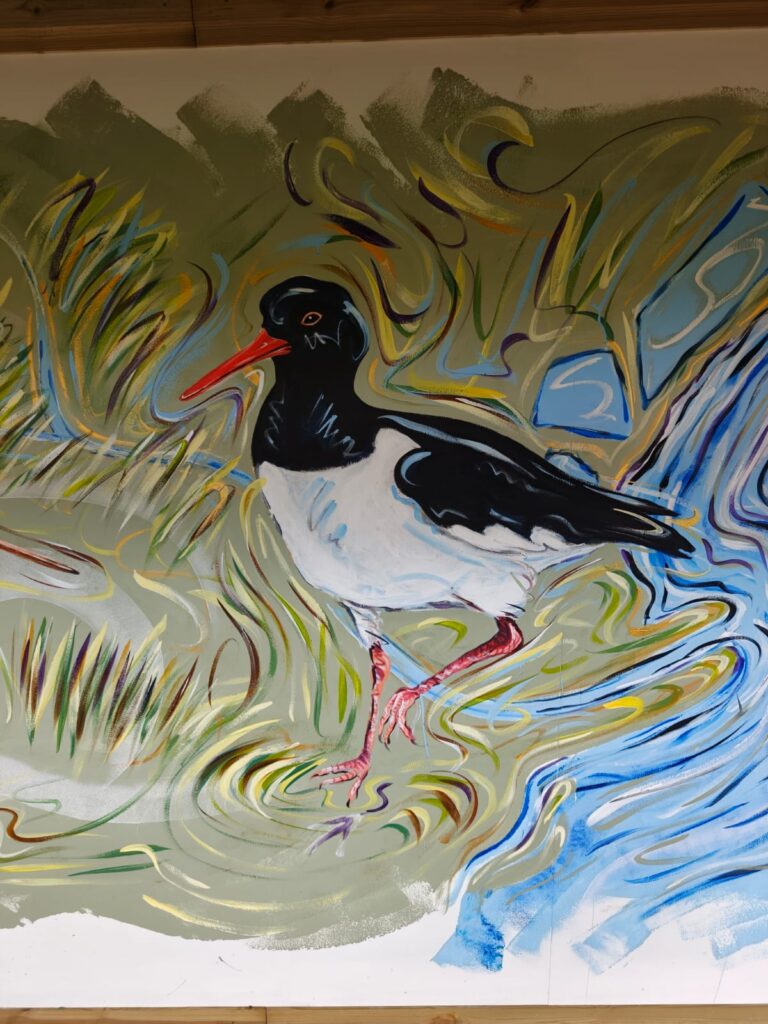 Detail of the Flyways Mural showing wetland birds among reeds and water at RSPB Freiston Shore.