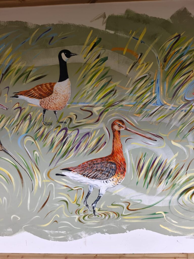 Detail of the Flyways Mural showing wetland birds among reeds and water at RSPB Freiston Shore.