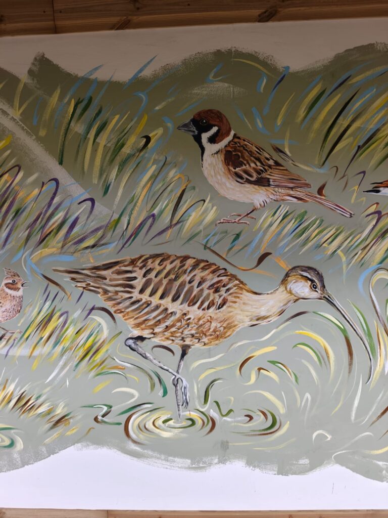 Detail of the Flyways Mural showing wetland birds among reeds and water at RSPB Freiston Shore.