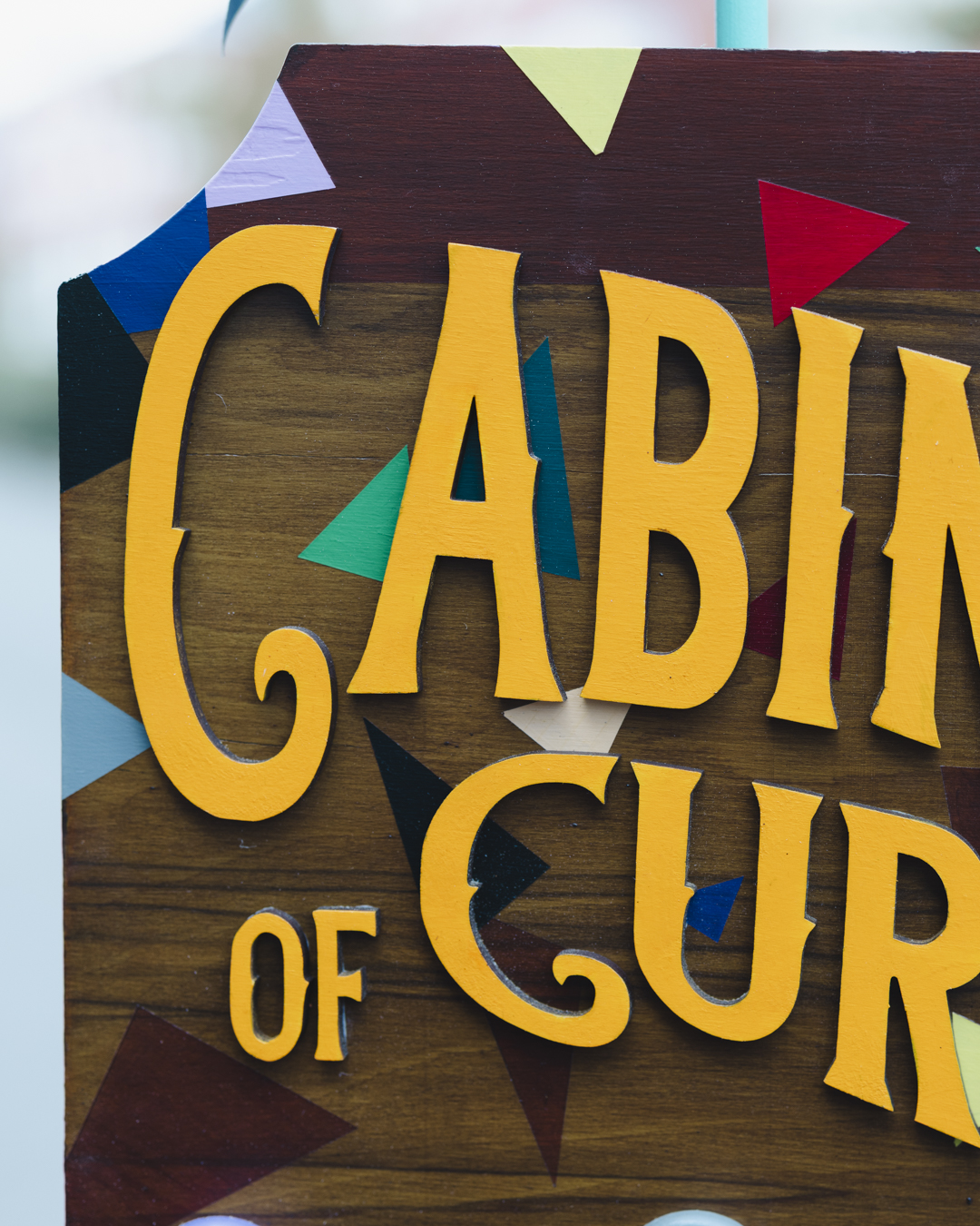 A close up image of the 3D Cabinet of Curiosities title affixed to the cabinet