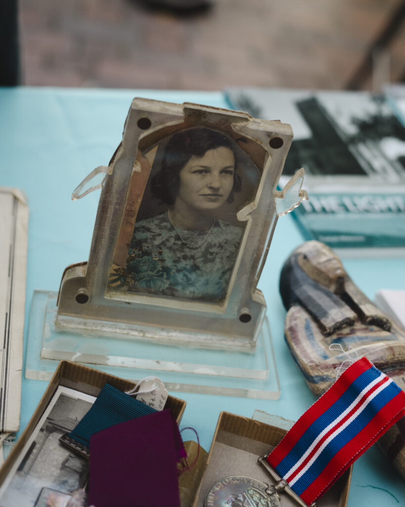 A close up image of vintage photograph in a frame, a part of the Spalding Gentlemen Society Museum's collection on a table with other artefacts